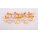 A set of eight early 20th Century carved and stained ivory Emperor's horses and a smaller similar