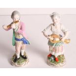 A pair of 19th Century Meissen porcelain figures of a girl playing a hurdy gurdy and a boy playing a