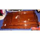 A set of three palm wood? graduated rectangular two-handled trays, largest 24" x 16"