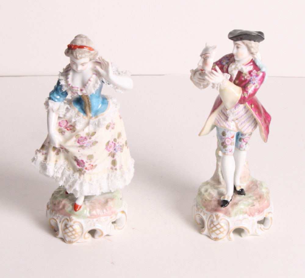 A pair of 19th Century continental porcelain figures of masquers in period costume, 7" high