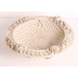 A Belleek woven china basket with floral encrusted border, 10" dia (handle missing)
