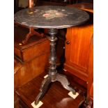 A Victorian black and gilt decorated tilt top occasional table with papier-mâché top painted
