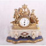 A late 19th Century gilt metal mounted mantel clock with attendant figures on marble base, 12" high,