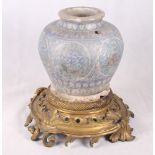 An Isnik pottery vase decorated in light and dark blue with circular floral panels, 10" high, with