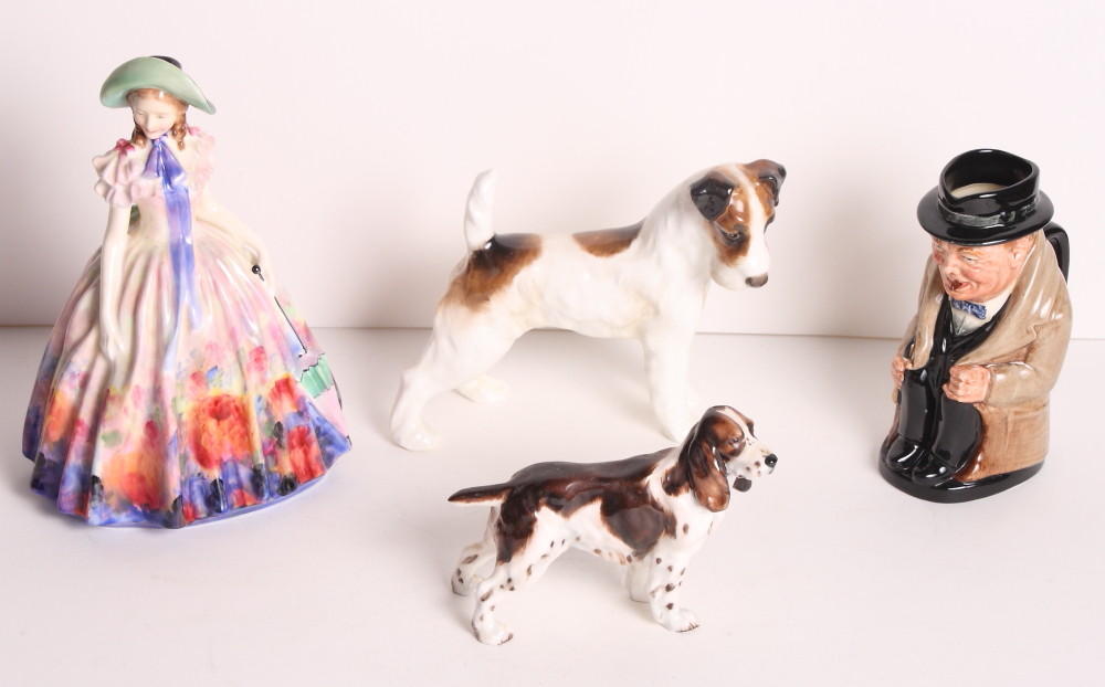 A Royal Doulton bone china figure, "Easter Day", a Winston Churchill Toby jug, a wirehaired fox