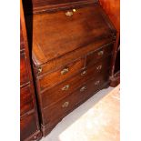An 18th Century oak bureau bookcase, the upper section enclosed two twin panelled doors, sloping