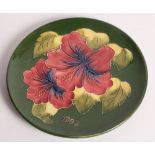 A Moorcroft Hibiscus pattern plate dated 1983, 9" dia