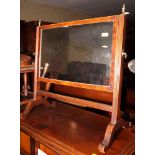 A 19th Century mahogany rectangular swing toilet mirror, on reeded standards, 19" wide