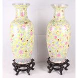 A pair of 20th Century Chinese porcelain baluster vases and stands with all-over foliate