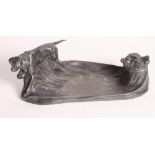 An Art Nouveau pewter inkstand with inkwell and gundog, 10" wide