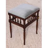 An Edwardian piano stool with spindle gallery, on turned and splayed supports