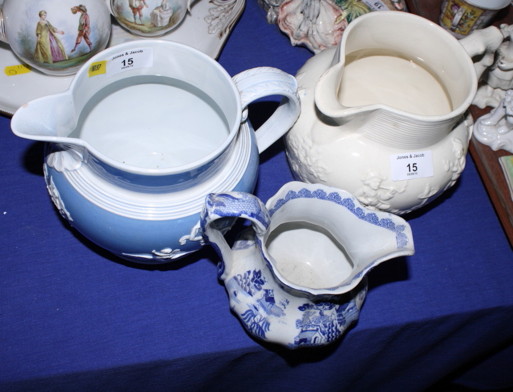 A Willow pattern ironstone jug, a 19th Century blue and white glazed jug with applied classical