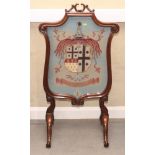 A Victorian rosewood framed firescreen carved scrolls, inset tapestry panel worked arms of the