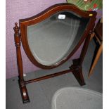 A mahogany framed swing toilet mirror with shield-shaped bevelled plate, 22" wide