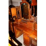 A Victorian mahogany breakfront dressing table, fitted mirror flanked by eight small drawers, base