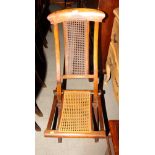 A Victorian folding chair with caned back and seat panels and a Victorian nursing chair with