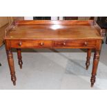 A Victorian mahogany side table with three-quarter gallery, fitted two frieze drawers, on turned