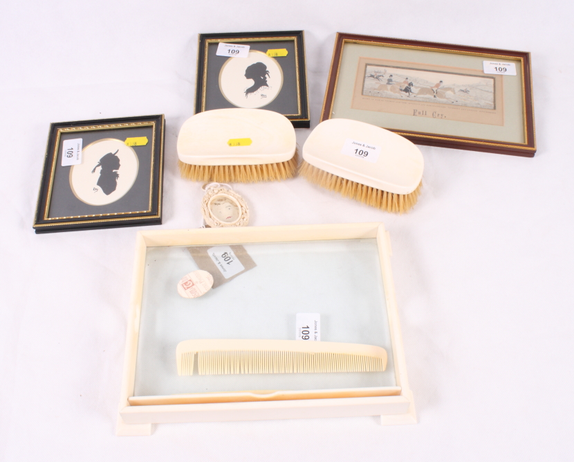 An ivory dressing table tray, two ivory backed clothes brushes, a miniature carved ivory frame and