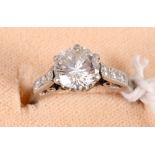 A platinum and diamond dress ring with central stone, 1.4ct approx, with three brilliant cut