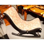 A Victorian hammock seat rocking chair with ebonised frame