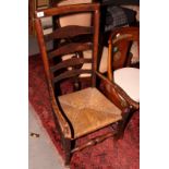 An 18th Century rush seat carver chair, back decorated three rows of spindles, and a similar rush