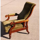 A Victorian mahogany framed recliner armchair with scroll carved arm terminals, upholstered in a
