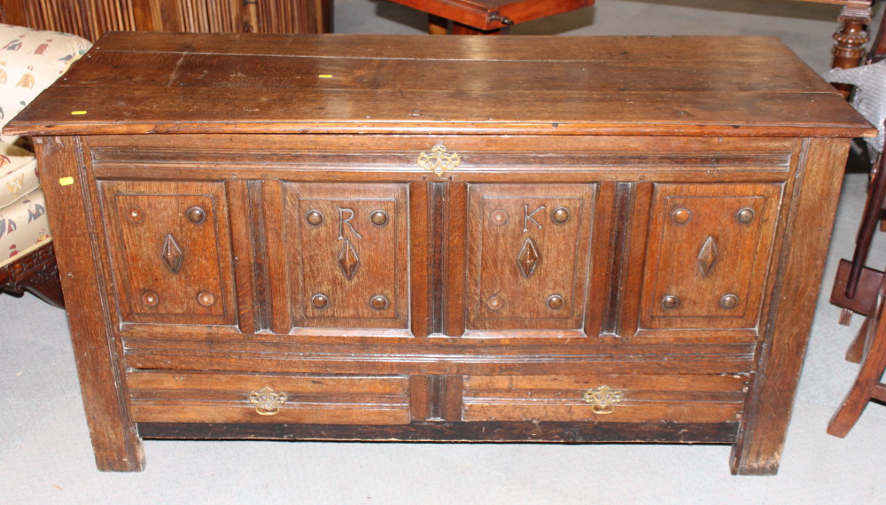 An 18th Century oak mule chest with four panelled front incised initials and decorated lozenges, 59"