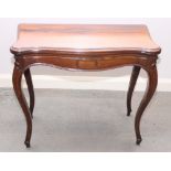 A Victorian rosewood fold-over top card table with serpentine front, on slender cabriole supports