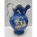 A large blue ground Victorian wash jug decorated with Romanesque scenes upon. Old repairs and