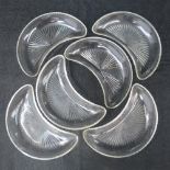 A set of six cut glass crescent shaped salad plates with minor chips to rims.