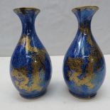 A pair of Wedgwood vases by Daisy Makeig Jones c1914, with mottled blue lustre glaze and decorated
