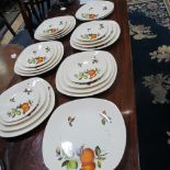 A vintage 23 piece set of Midwinter style craft china plates, graduated sizes c.1960s