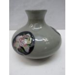A Moorcroft trial squat shaped vase with rose decorated panels.