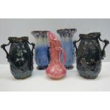 A pair of early 20th century, twin handled dark blue vases decorated in the oriental style with