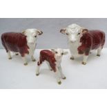 A Beswick Hereford trio comprising bull, cow and calf all in fine condition throughout
