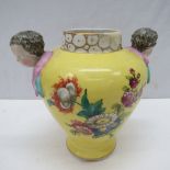 An early Continental porcelain twin handled vase, the handles fashioned as cherubic heads, the