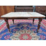 A Victorian mahogany dining table raised