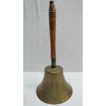 A large handbell with turned wooden hand