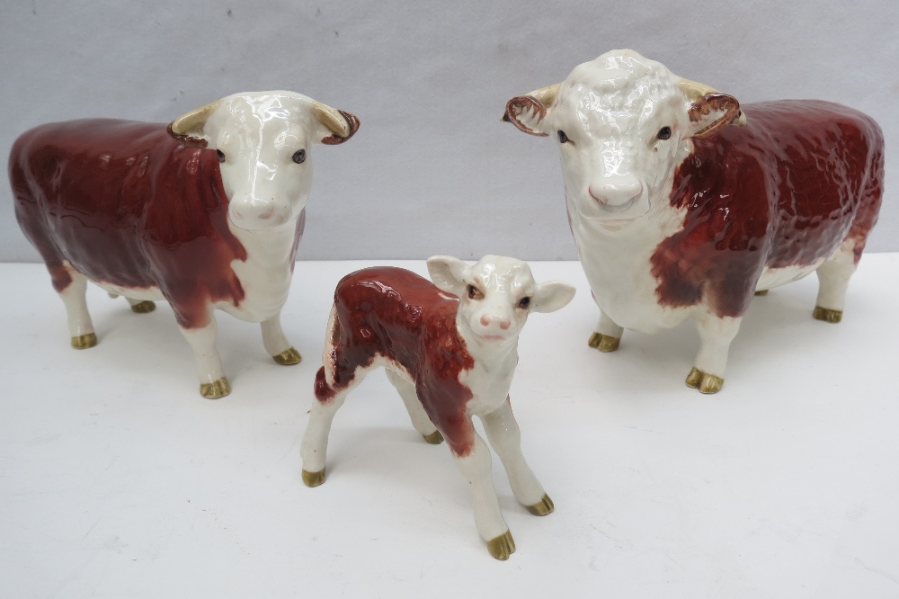 A Beswick Hereford trio comprising bull,