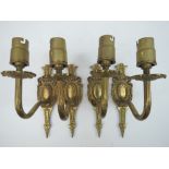 A set of four classical style brass wall