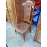 A late 19thC caned low seated high backe