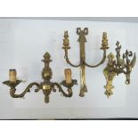 A brass wall sconce in the form of a sil