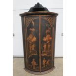 A Chinoiserie bow fronted corner cabinet