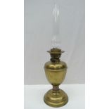 A brass oil lantern with glass funnel