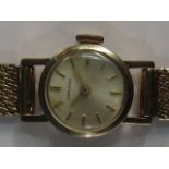 A ladies Longines 9ct gold watch, round