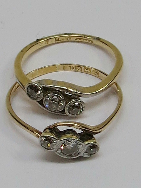 Two diamond three stone cross-over rings