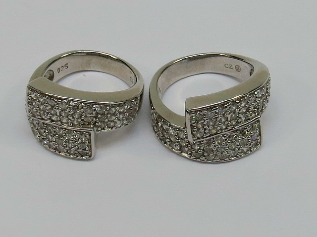 A pair of handmade crossover rings marke