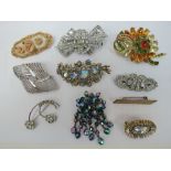 A collection of costume brooches. Ten it