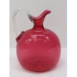 A Victorian cranberry glass jug. 18cm.