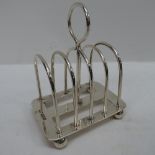 An HM silver four slice toast rack, mark